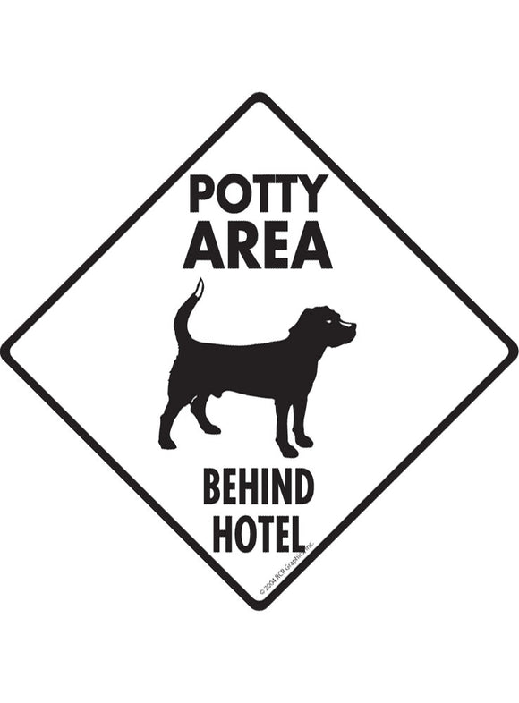 Potty Area with Dog Standing and Behind Hotel Signs or Sticker